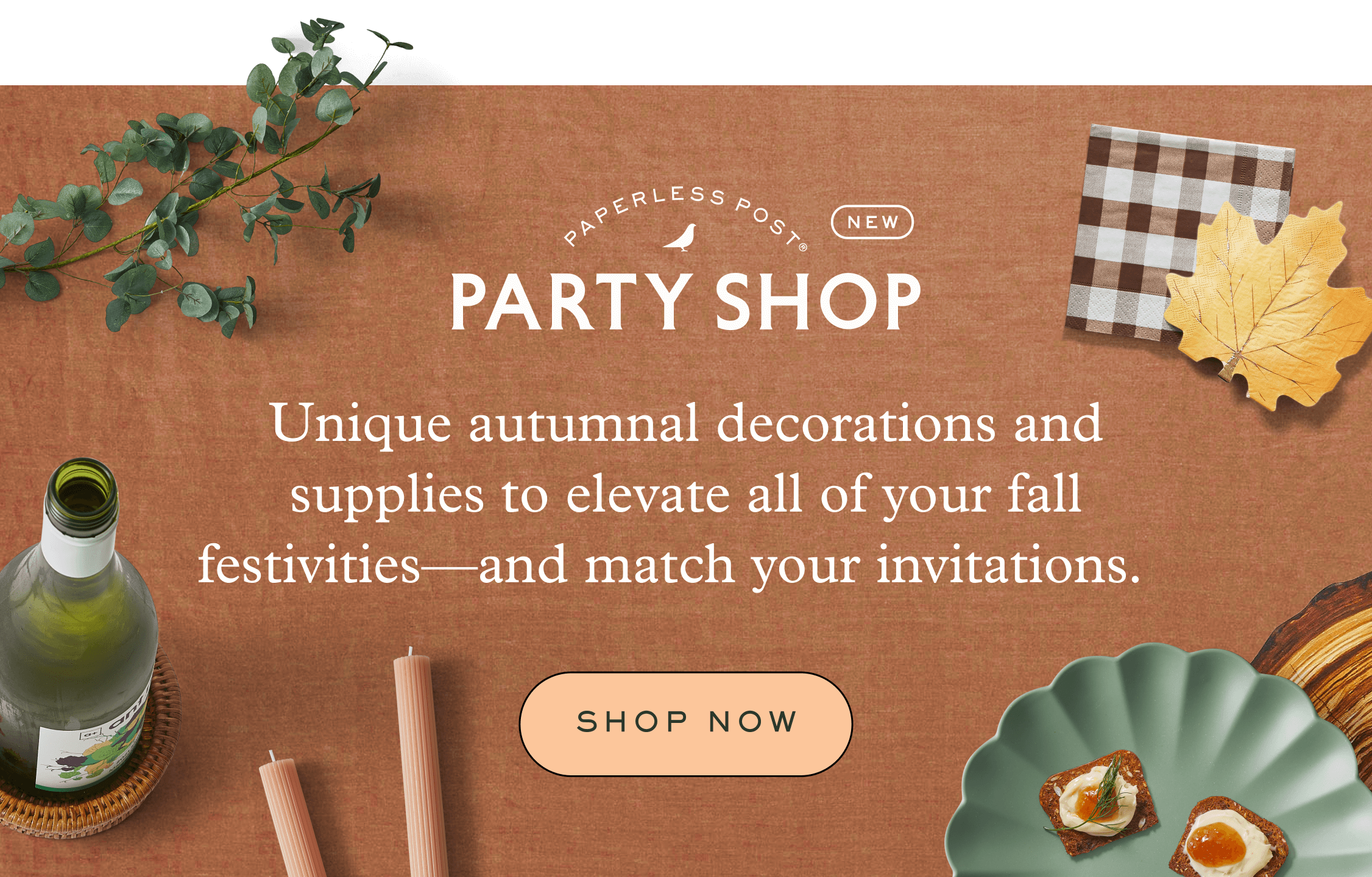 Green leaf garland, place cards, etched terracotta pillar candles, scalloped green plates and brown checked napkins on top a rust table cloth. Unique autumnal decorations and supplies to elevate all of your fall festivities—and match your invitations. Shop Now on Party Shop.